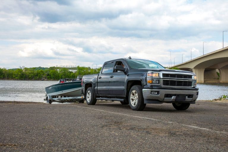Truck with Boat in summer goes fishing on the wide river, What Pickup Trucks Can Tow 7,000 Lbs?