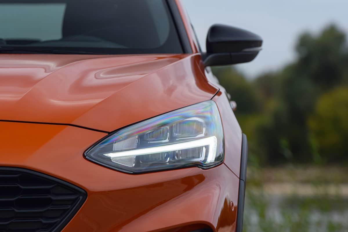 View on the LED headlight with blinker in Ford Focus Active on a street. The Focus is one of the most popular compact cars on the European market.