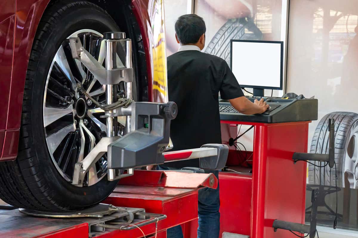 Wheel alignment ,Car on stand with sensors on wheels for wheels alignment camber check in workshop