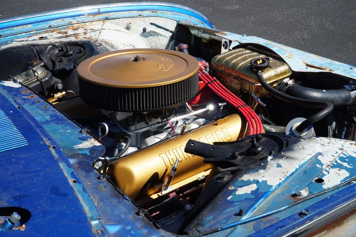 he engine of a old car paints and fixed up as rolling art.