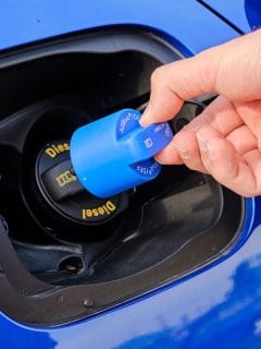 mans hand opening a tank for Ad Blue fluid of a blue car, Diesel Exhaust Fluid Will Not Reset - Why And What To Do?