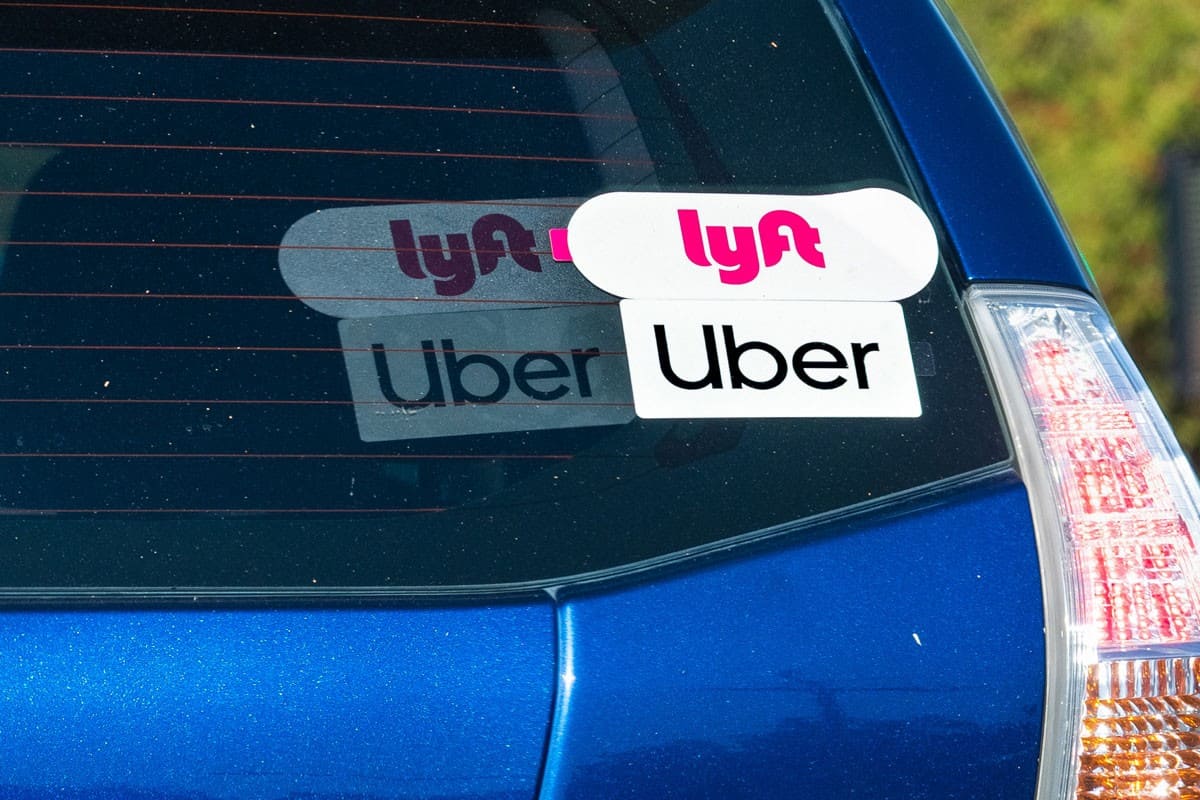 uber cling sticker on the rear window of a blue vehicle