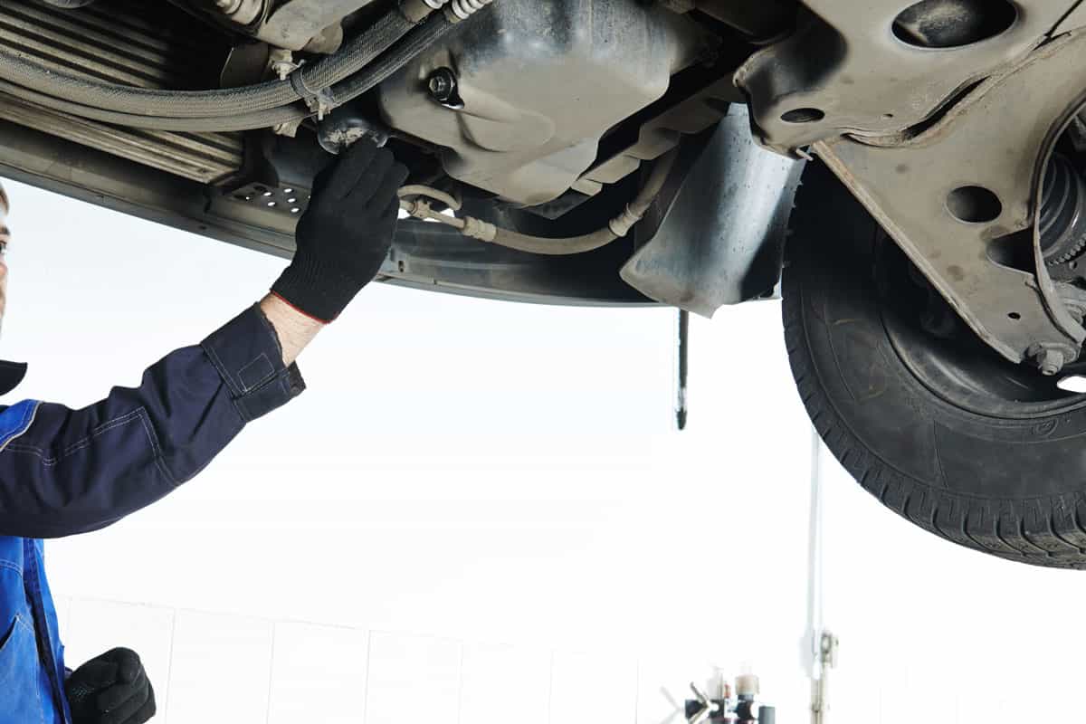 Car servicing, replacing of motor oil and filter at auto repair shop