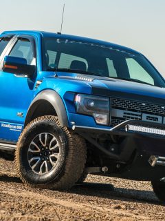 Ford F150 Raptor SUV is on the road driving on dirt, Ford F150 Speaker Upgrade - What Options Do You Have?