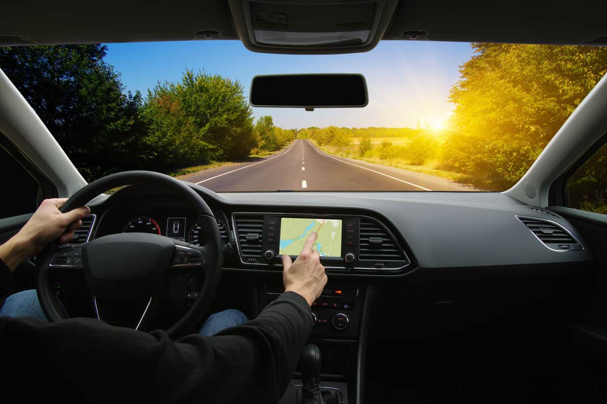 Man hand using GPS navigation inside car