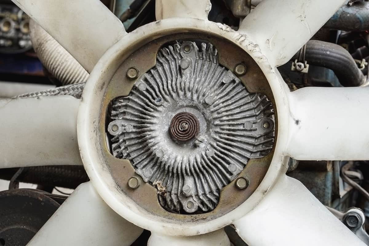 Old vehicle fan clutch attached with plastic engine blades fan