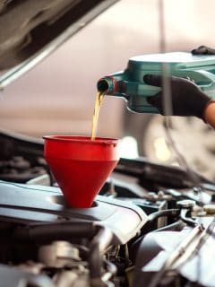 Pouring oil to car engine, Mechanic pouring oil into car at the repair garage - What Is The Best Oil For A Volkswagen Jetta