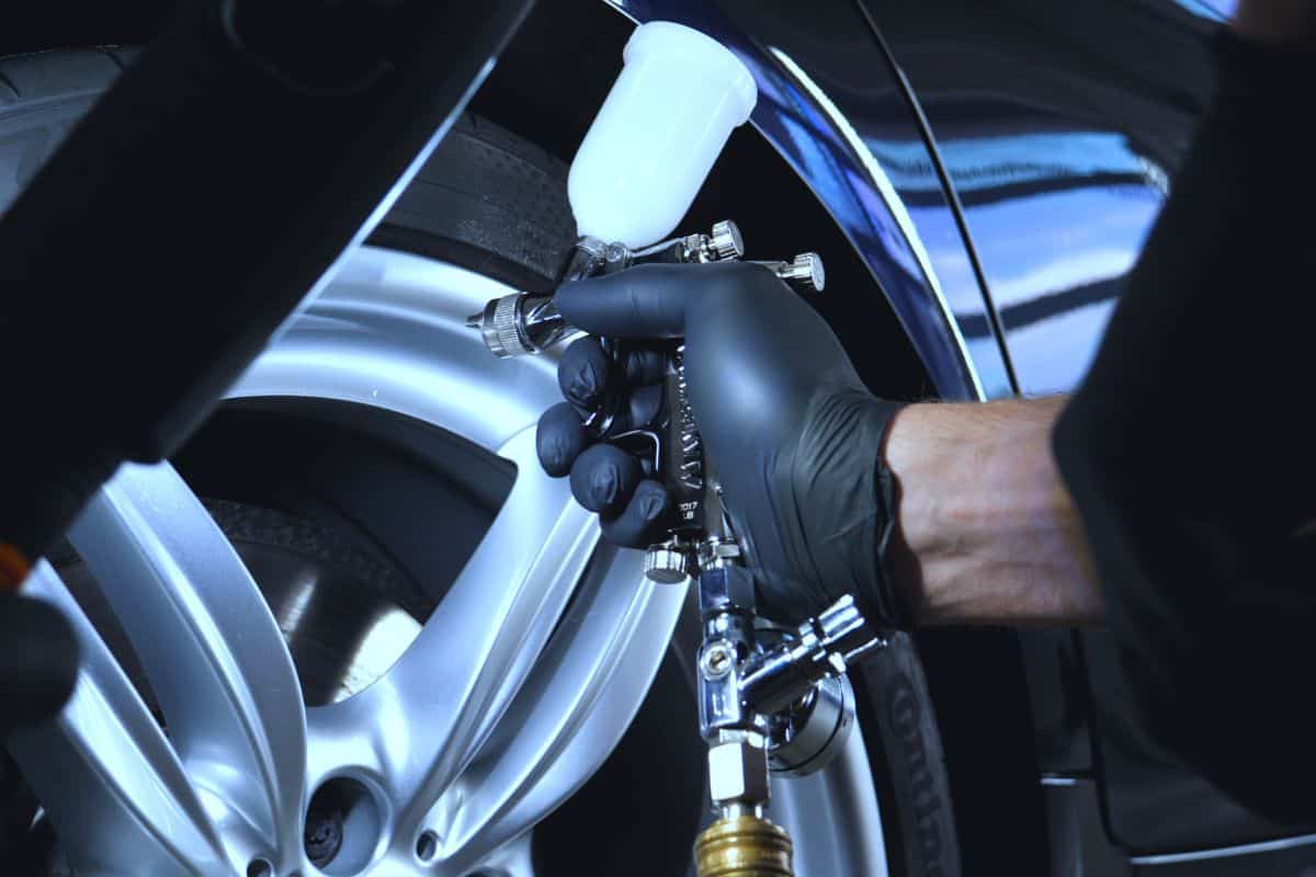 Professional coating of ceramic wheels and rubber, spray gun for painting, car service, shop, washing.