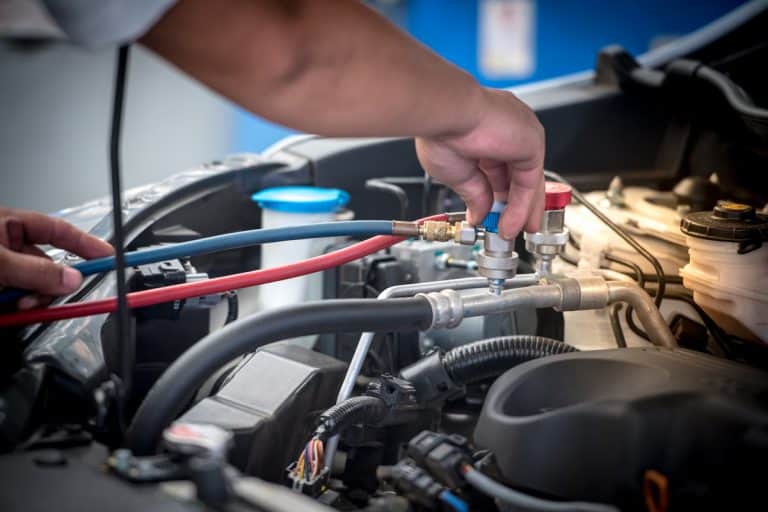 Servicing car air conditioner. Service station. Car repair. auto mechanic Check the pressure and leak. for use on air condition systems, Freon Leak In Car - Is It Dangerous? What To Do?