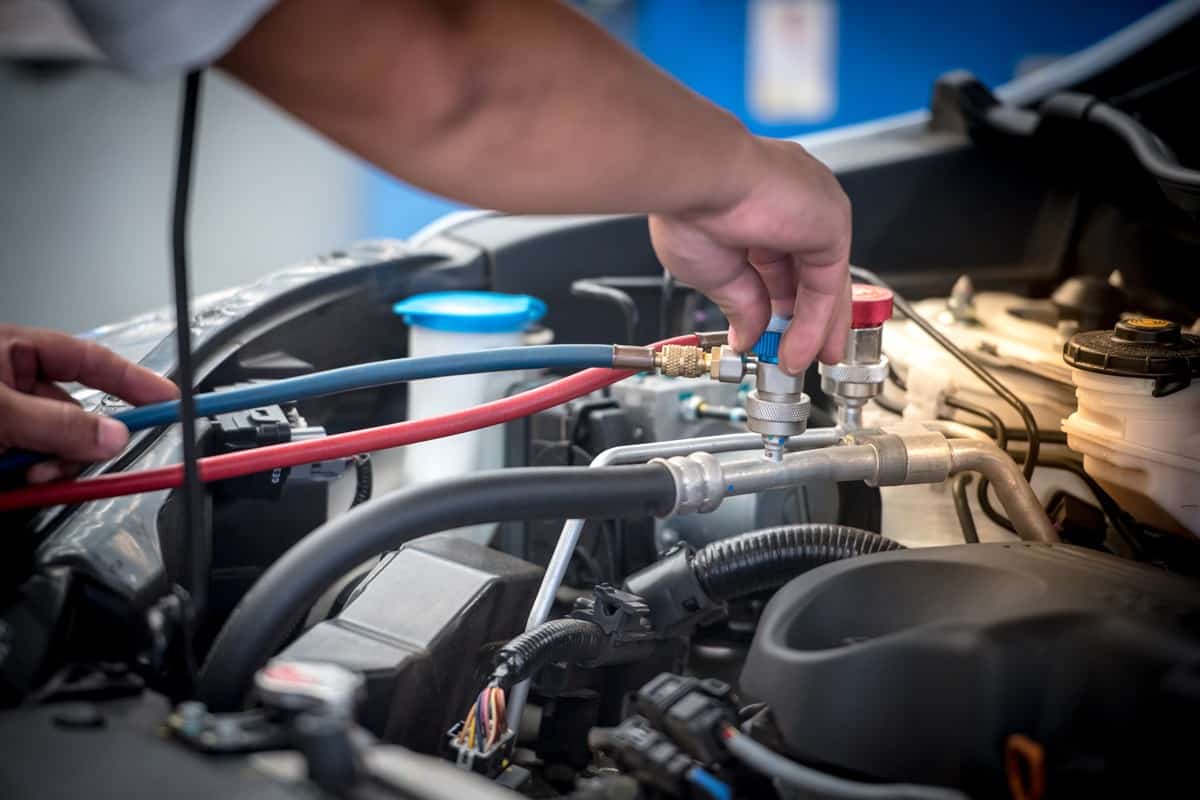 Servicing car air conditioner. Service station. Car repair. auto mechanic Check the pressure and leak.