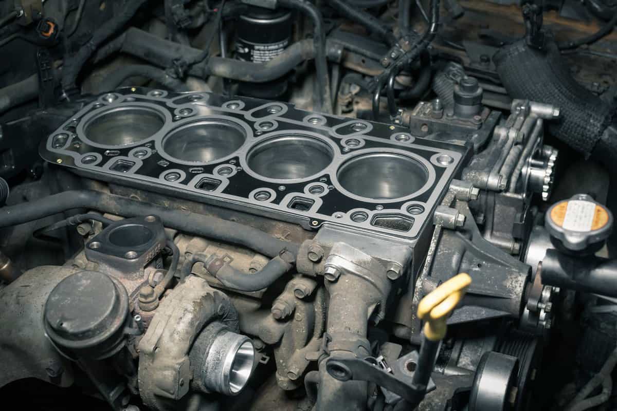 Short block with installed cylinder head gasket. Repair of a turbocharged diesel engine in a car workshop. Blur effect.