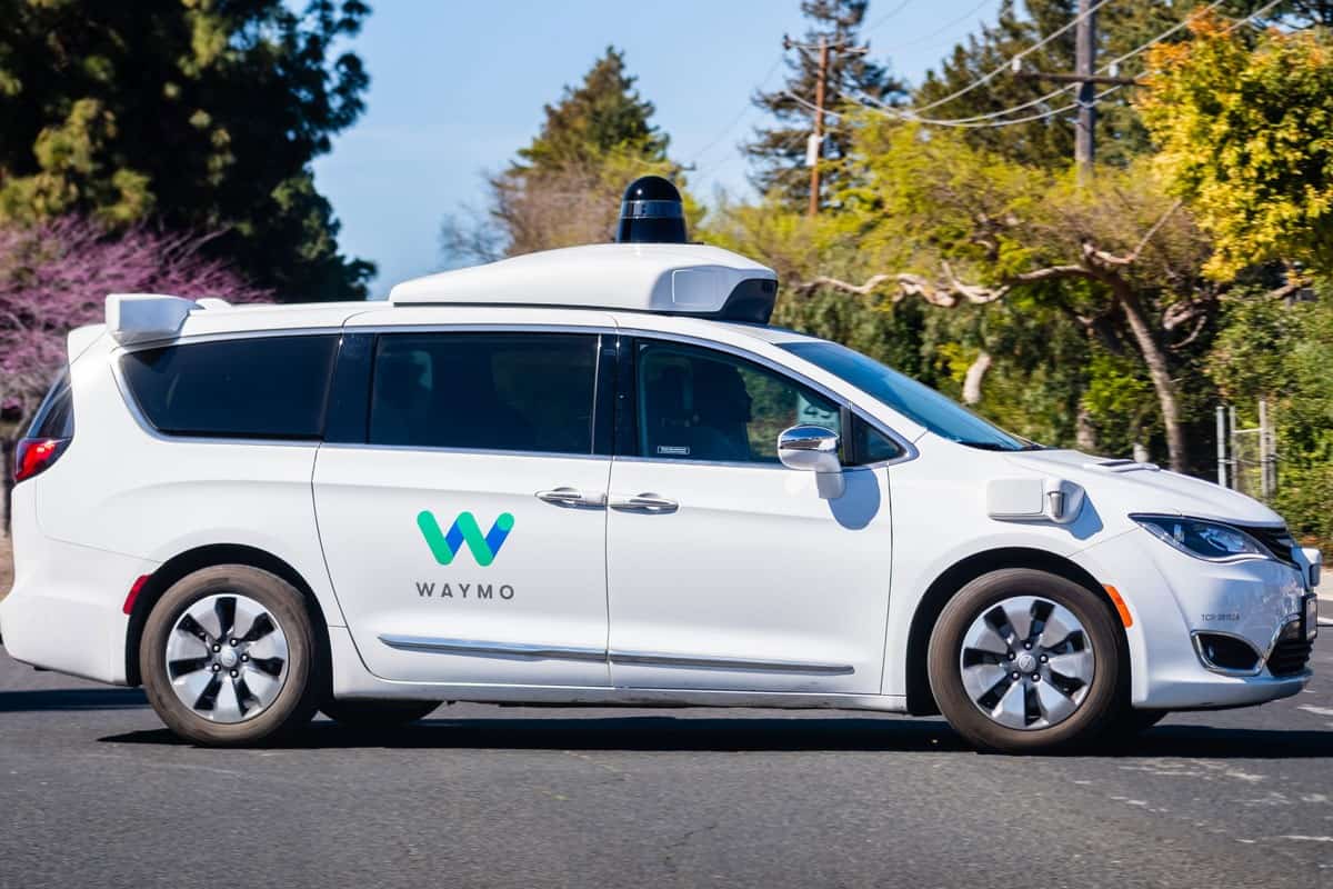Waymo self driving car performing tests on a street side view