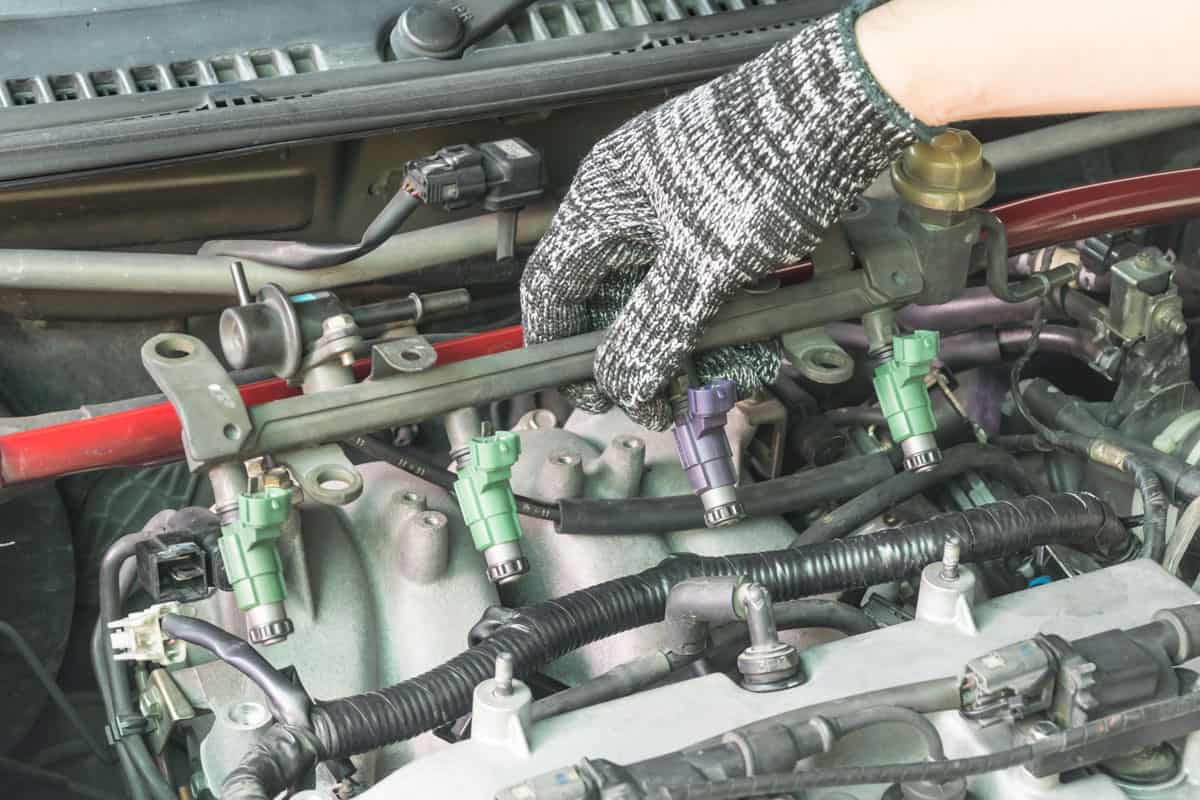 car-mechanic-checking-fuel-injector-system