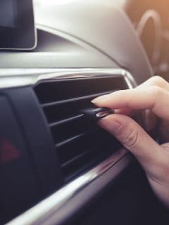 closeup-female-hand-adjusting-air-ventilation, Can Overcharging Car AC Damage The Compressor?