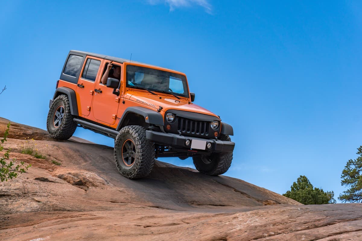 A modified Jeep Wrangler on sandstone