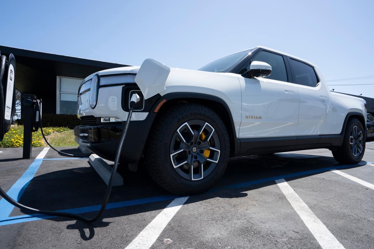  A new Rivian R1T truck is charging at a Rivian service center in South San Francisco, California.