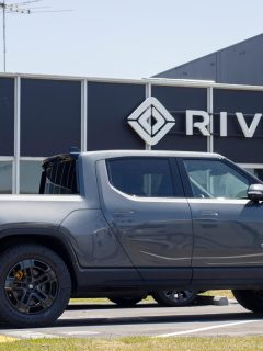 A new Rivian R1T truck is seen at a Rivian service center in South San Francisco, California. Rivian Automotive, Inc. is an electric vehicle automaker., Does Rivian Come With Charger?