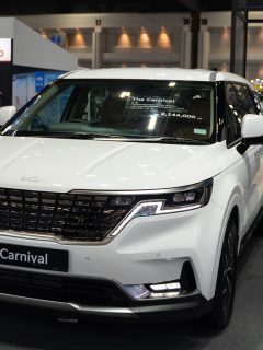 A white Kia Carnival displayed at a car show, My Kia Carnival Won't Go Into Park - Why? What To Do?