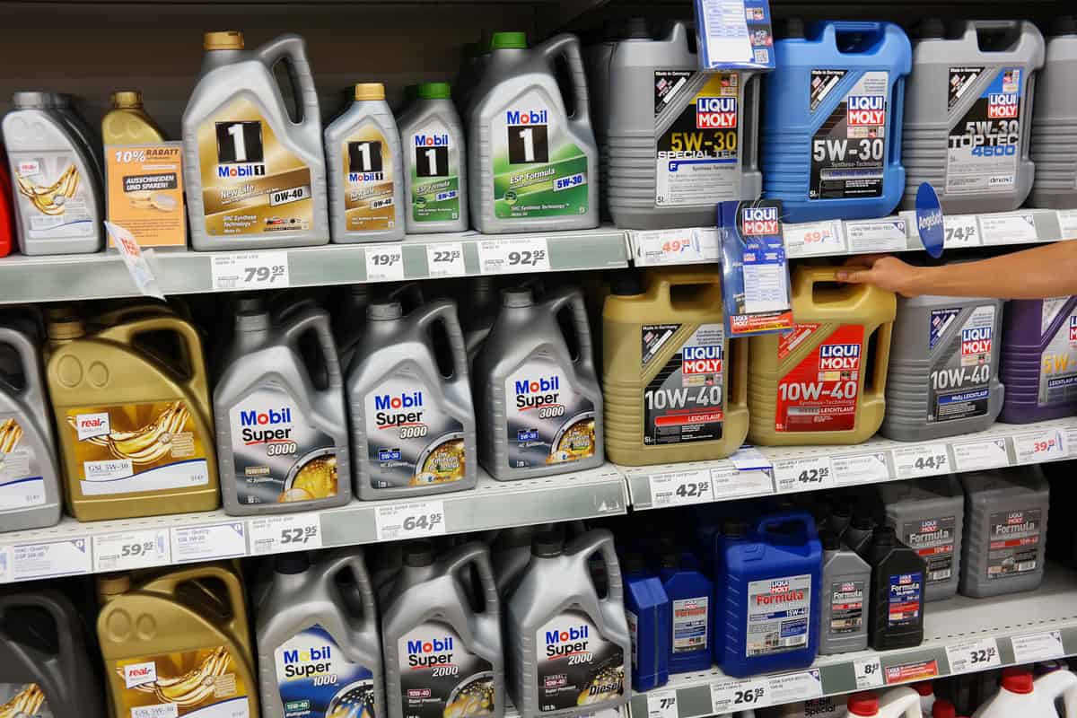 Automobile Motor Oil on a Supermarket aisle of a Real hypermarket. Engine oil is used for lubrication of various internal combustion