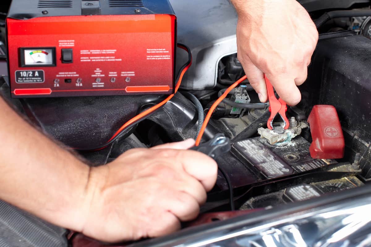 Battery charger and car in auto repair shop