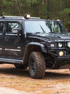 Black Hummer H2 vehicle stands on dirty country road, Can You Flat Tow A Hummer H2 Or H3