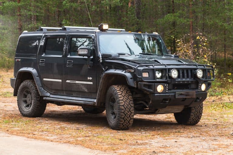 Black Hummer H2 vehicle stands on dirty country road, Can You Flat Tow A Hummer H2 Or H3