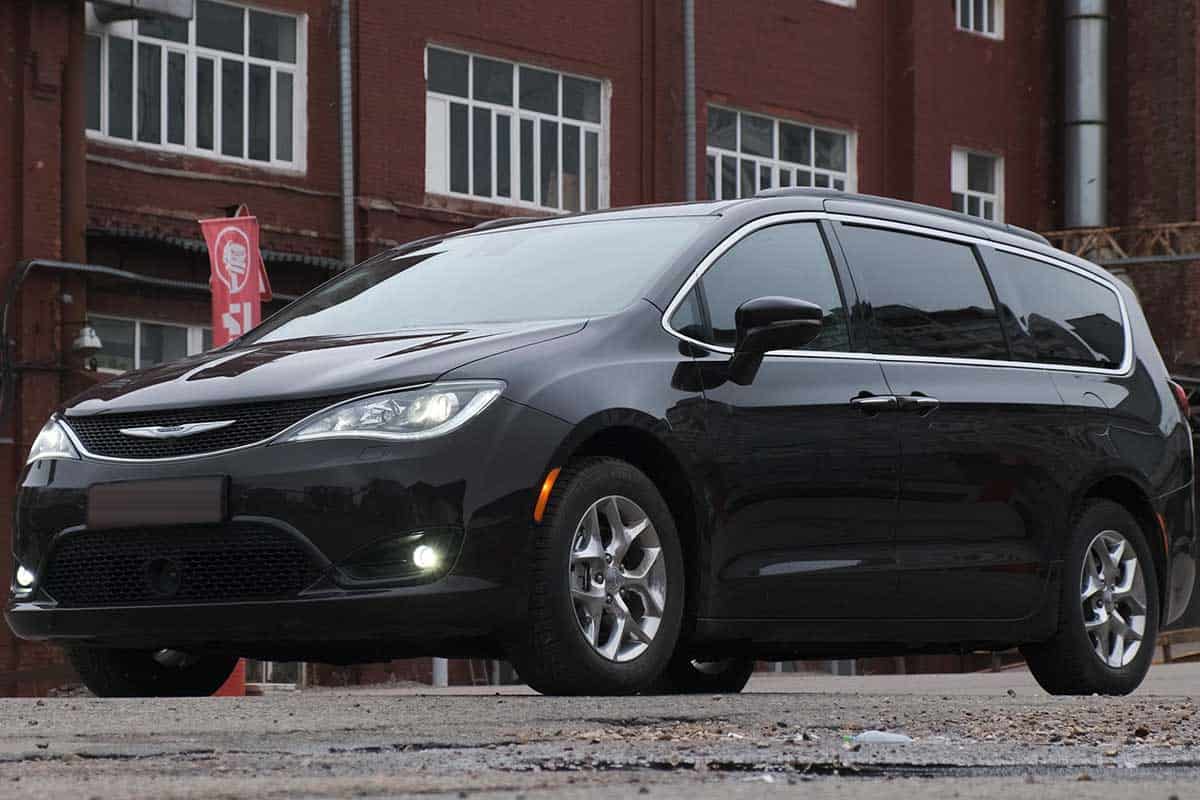 Black minivan Chrysler Pacifica on parking lot