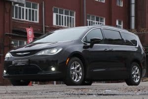 Black minivan chrysler pacifica 2020 model on parking lot from side front - Where Is The Spare Tire On A Chrysler Pacifica