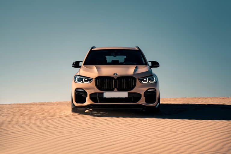 Brand new SUV BMW X5 in the desert. Desert dunes under sun rays, My BMW Check Engine Light Is On But Gives No Message Or Codes - Why? What To Do?