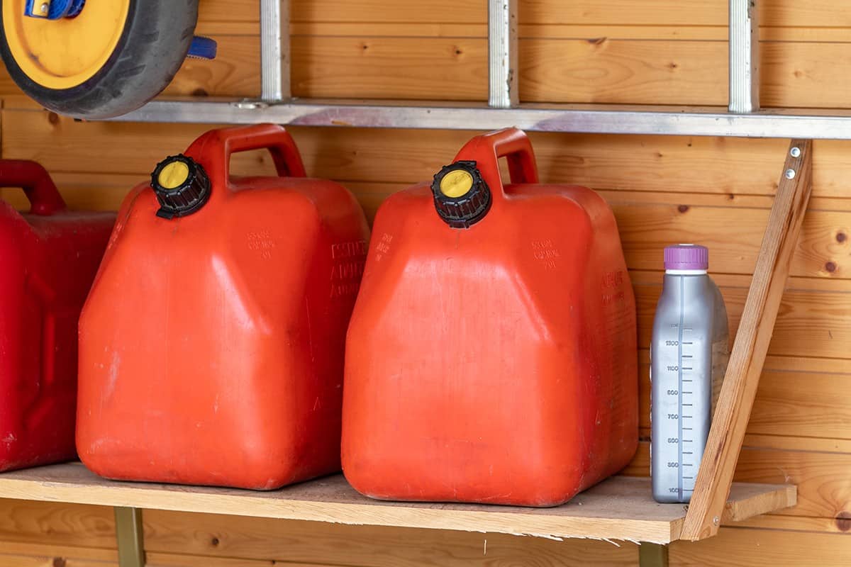 Garage corner with three red plastic fuel cans