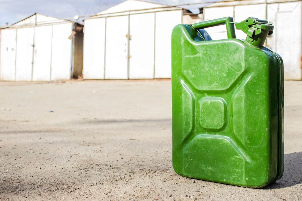 Green jerry can close-up on blurred background of garages