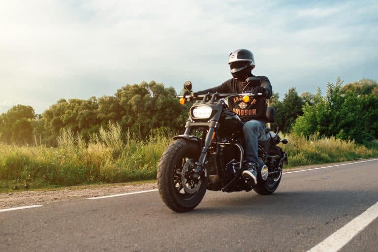 Harley Davidson Fat Bob 114 2020 motorcycle driver riding alone on a freeway, Why Does My Harley Davidson Pop On Deceleration? What Could Be Wrong?