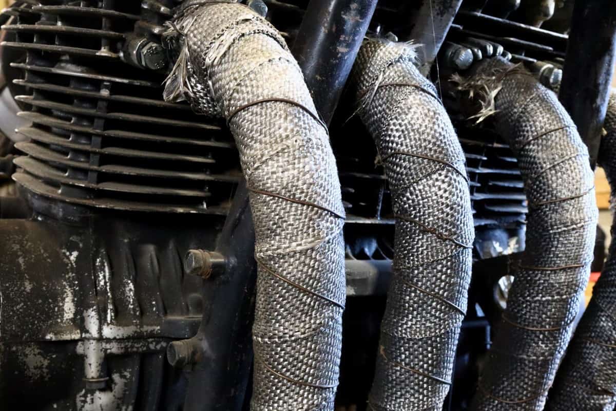 Heat wrapped exhaust of four cylinder cafe racer engine