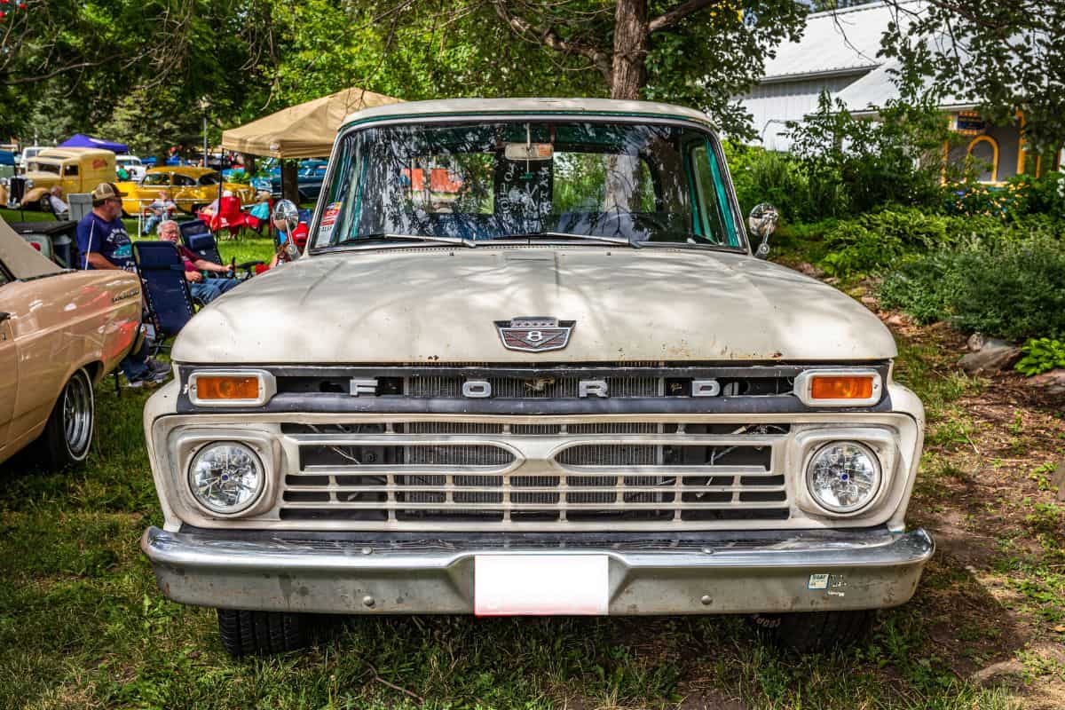 High perspective front view of a 1966 Ford F-250 Custom Cab Camper Special at a local car show.