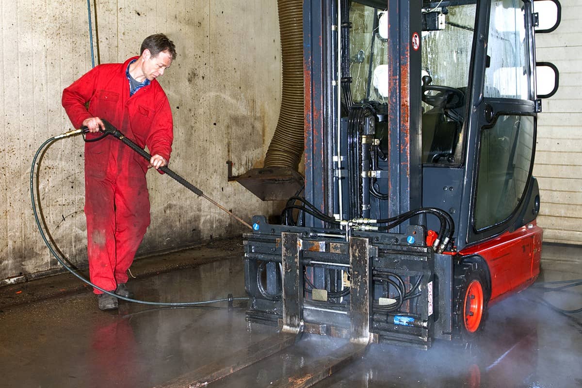 Man cleaning forklift