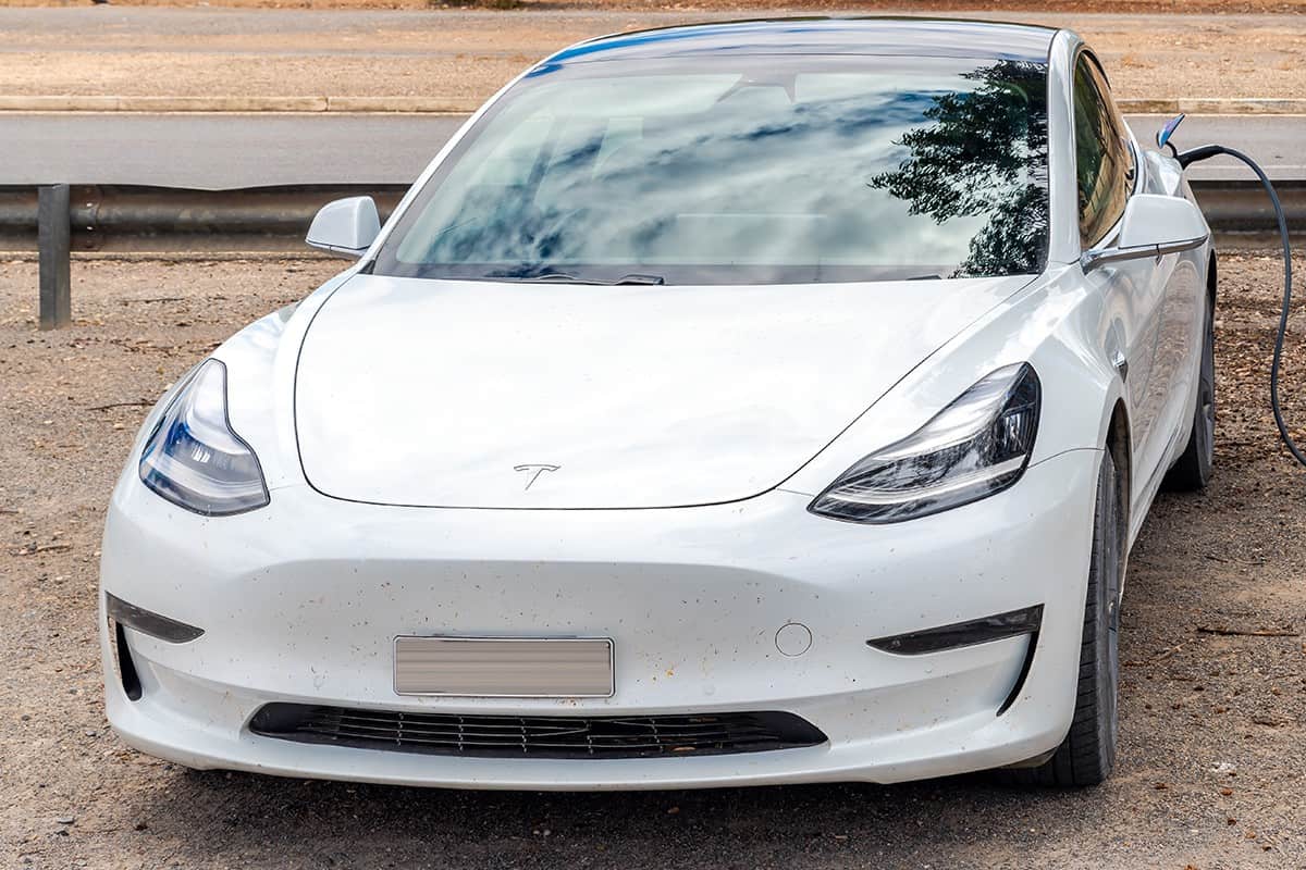 Model 3 Tesla car recharging along the road