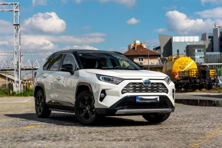 New Toyota RAV 4 Hybrid. Modern SUV transport vehicle in urban environment with blue sky in background. White Toyota car with new Hybrid technology., How Much Weight Can A Toyota Rav4 Carry?