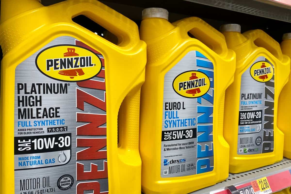 Pennzoil Platinum High Mileage 5 quart oil containers inside car maintenance department of Walmart