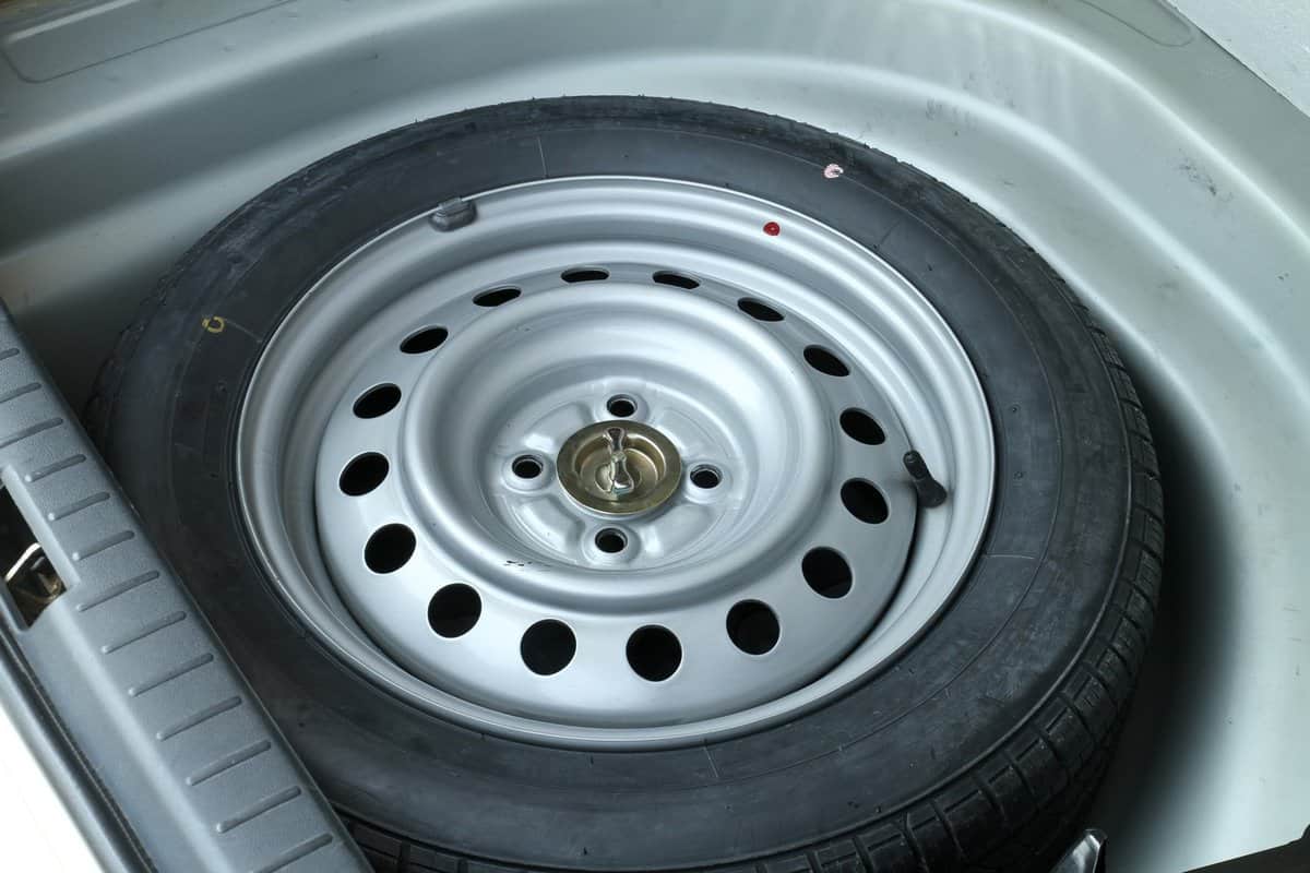 Spare wheel in storage bin on a car 