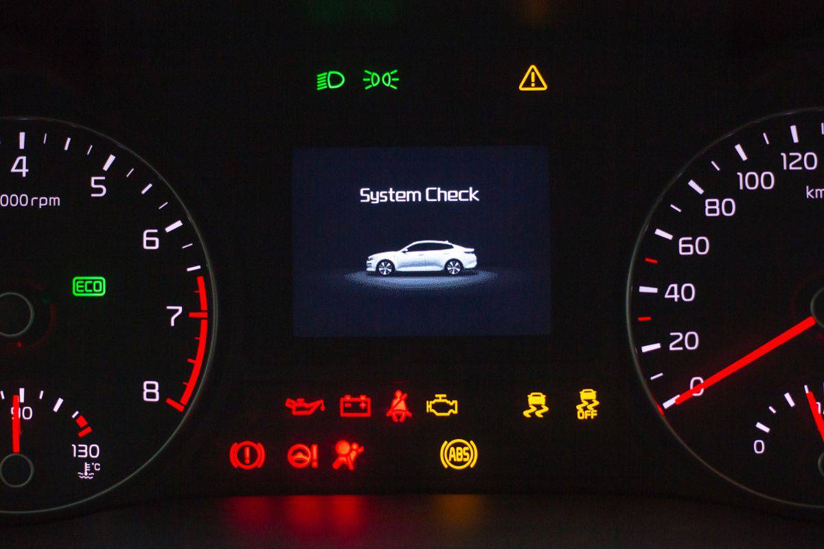 System check on engine start. Speedometer and tachometer with additional instruments on car dashboard.