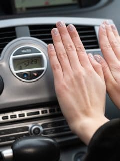 The girl holds her hands over the car's hot air outlet., Does A Car Heater Work With The Engine Off?