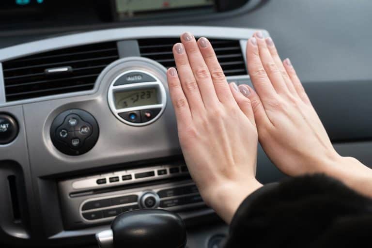 The girl holds her hands over the car's hot air outlet., Does A Car Heater Work With The Engine Off?