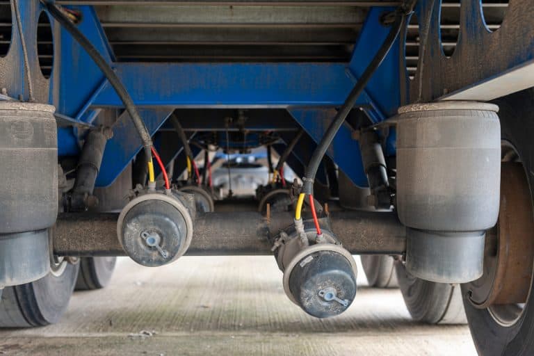 Underneath View of a Semi Trailer showing the Three Axles and Air bags and Brake Chambers with one of the Offside Rear Broken off the Axle with Shallow focus., Can You Use Airbags With A Weight Distribution Hitch? Should You?