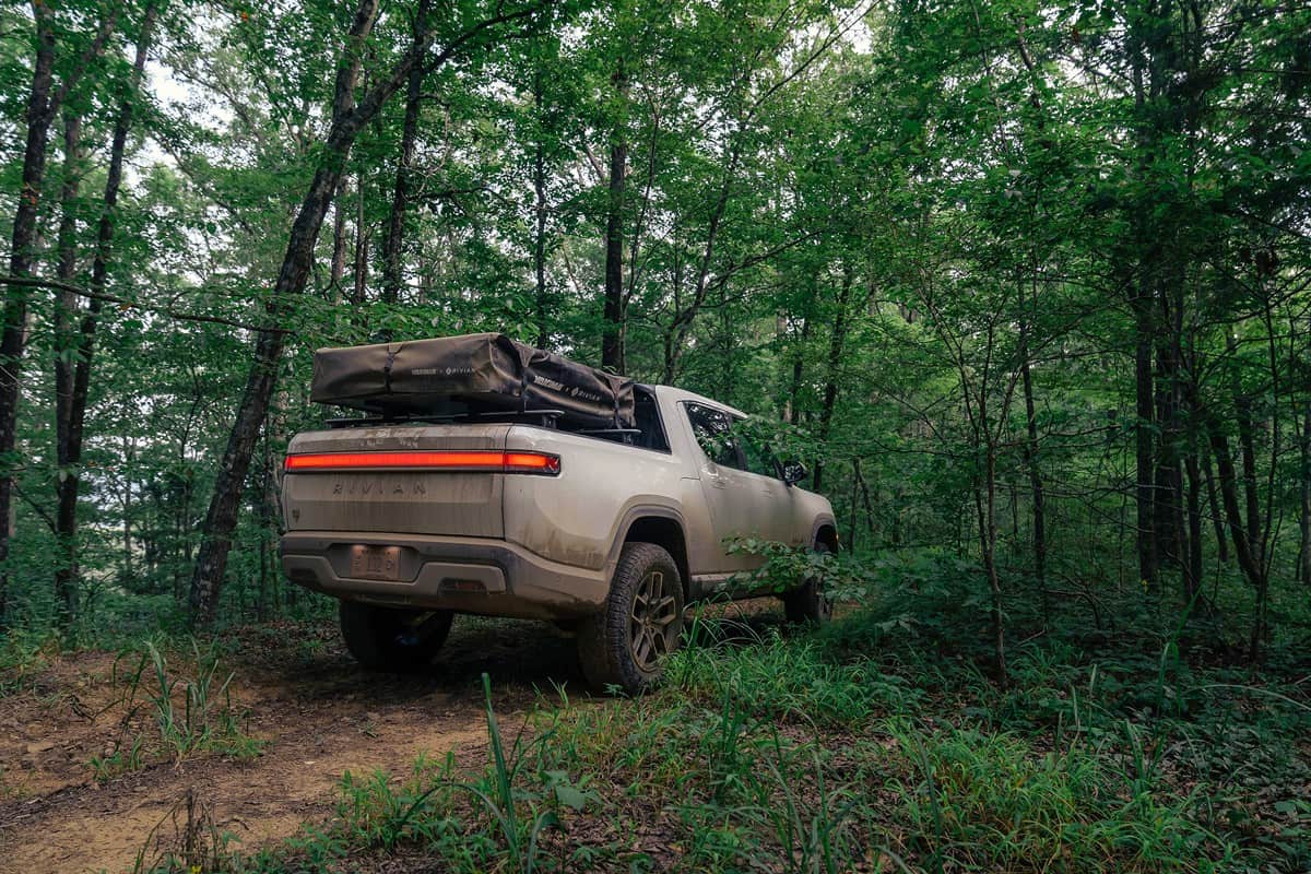 electric pickup truck Rivian R1T in the forest