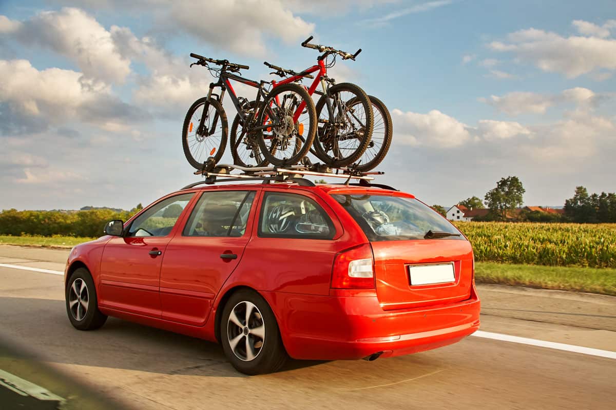 family car is transporting bicycles on rack. bikes on the trunk
