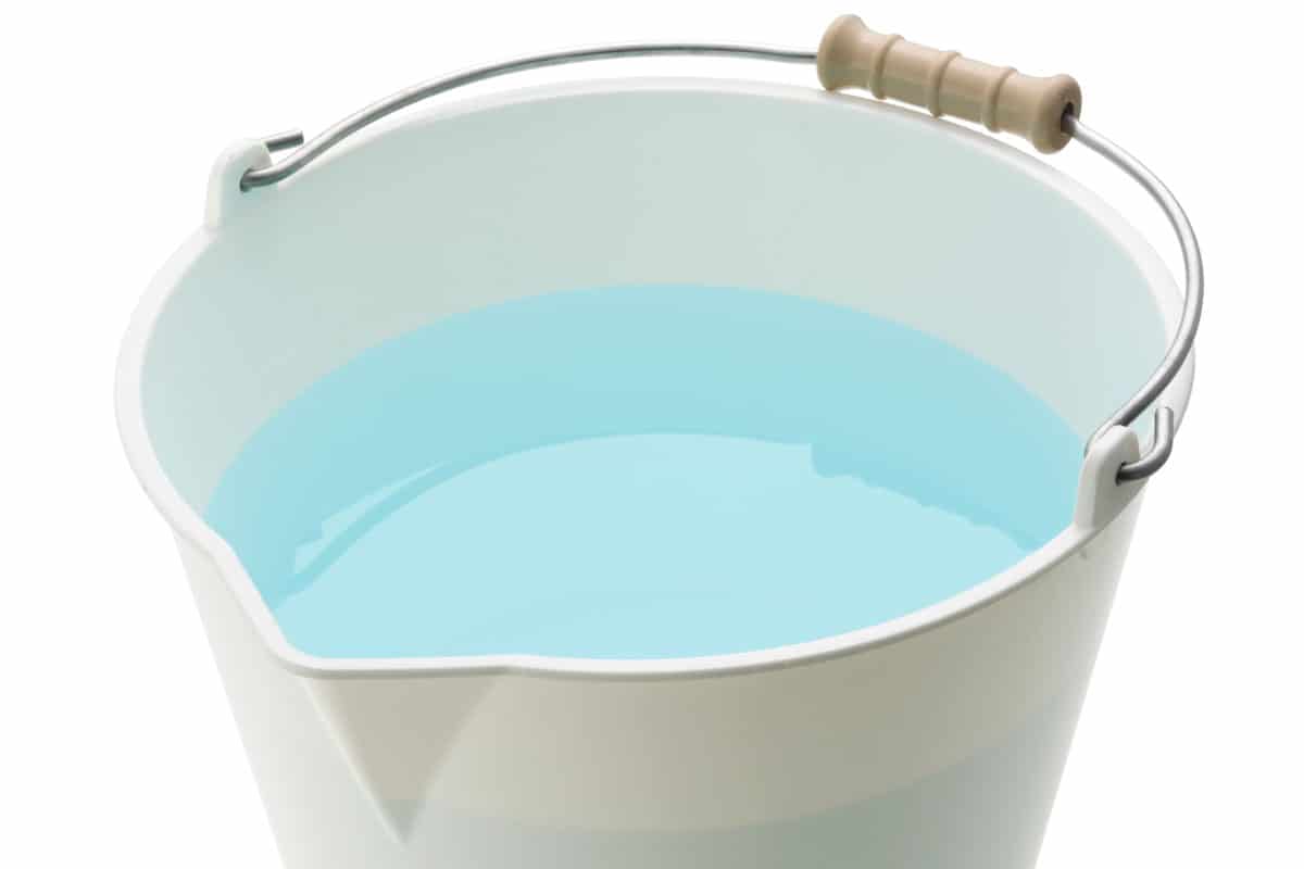 white bucket pale white background water inside clear clean warm water