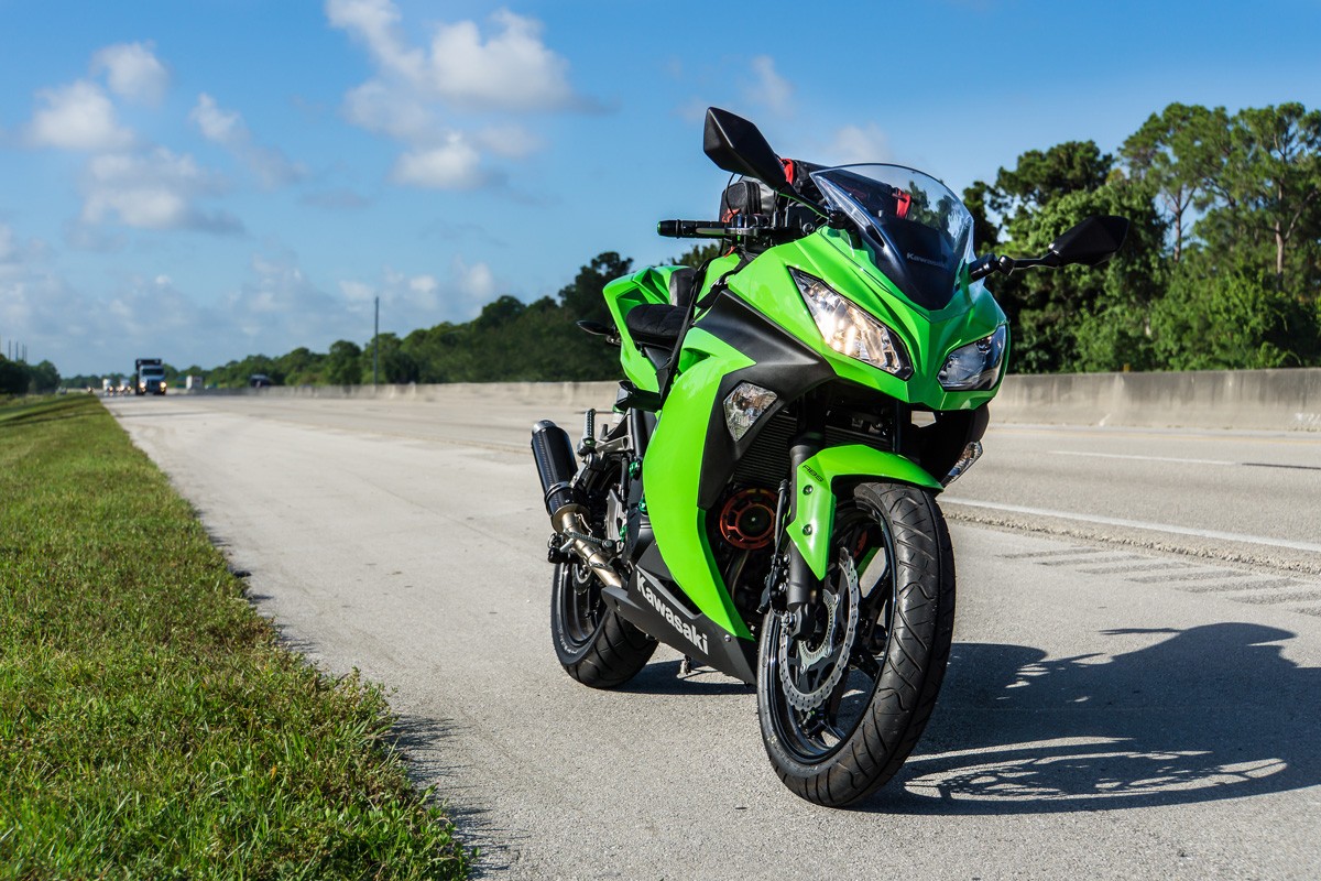 2015 Kawasaki Ninja 300 ABS parked on the side of a highway during a touring road-trip.