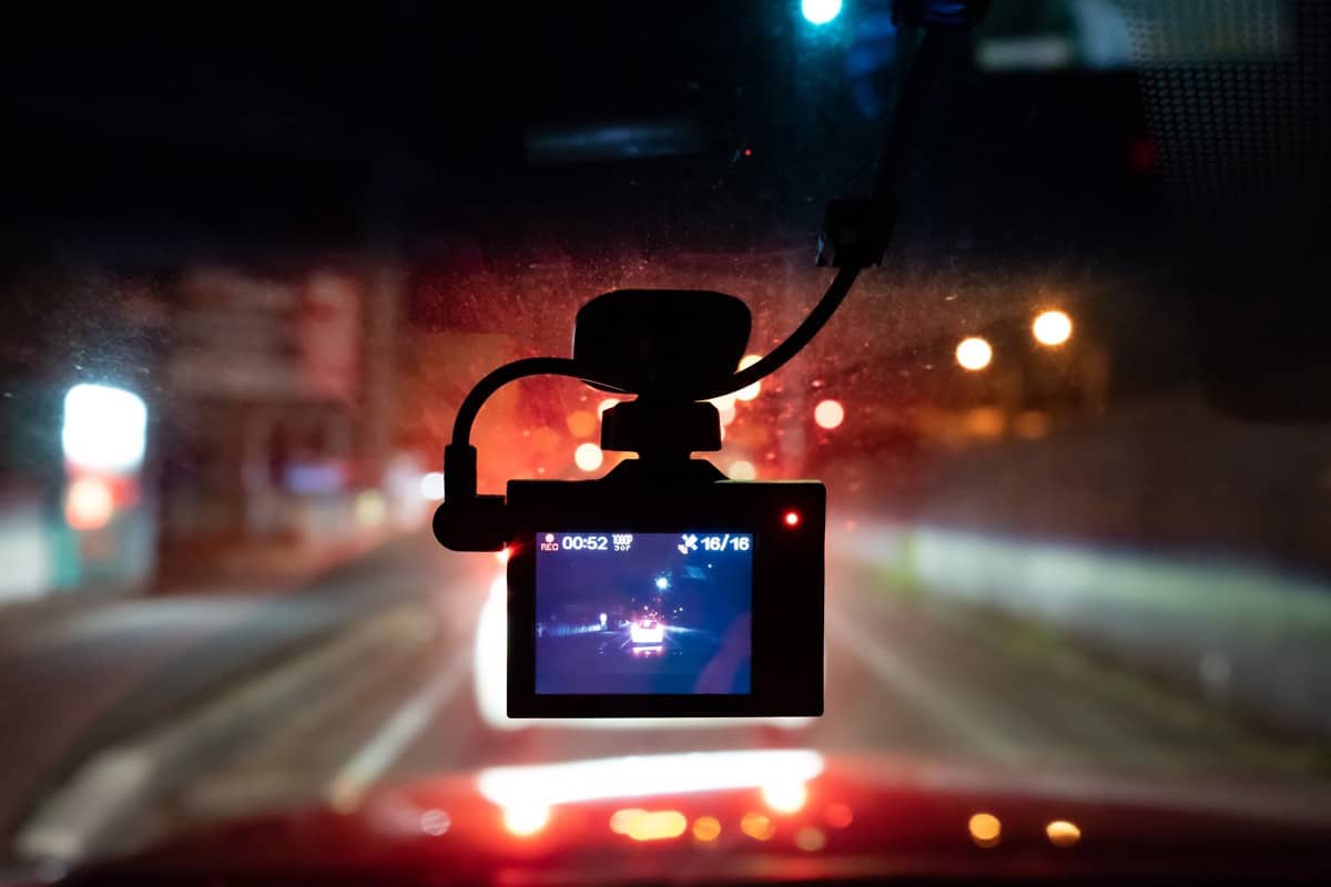 A dashcam is shooting forward in the evening