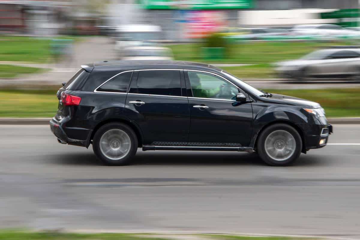 Black Acura MDX car moving on the street.