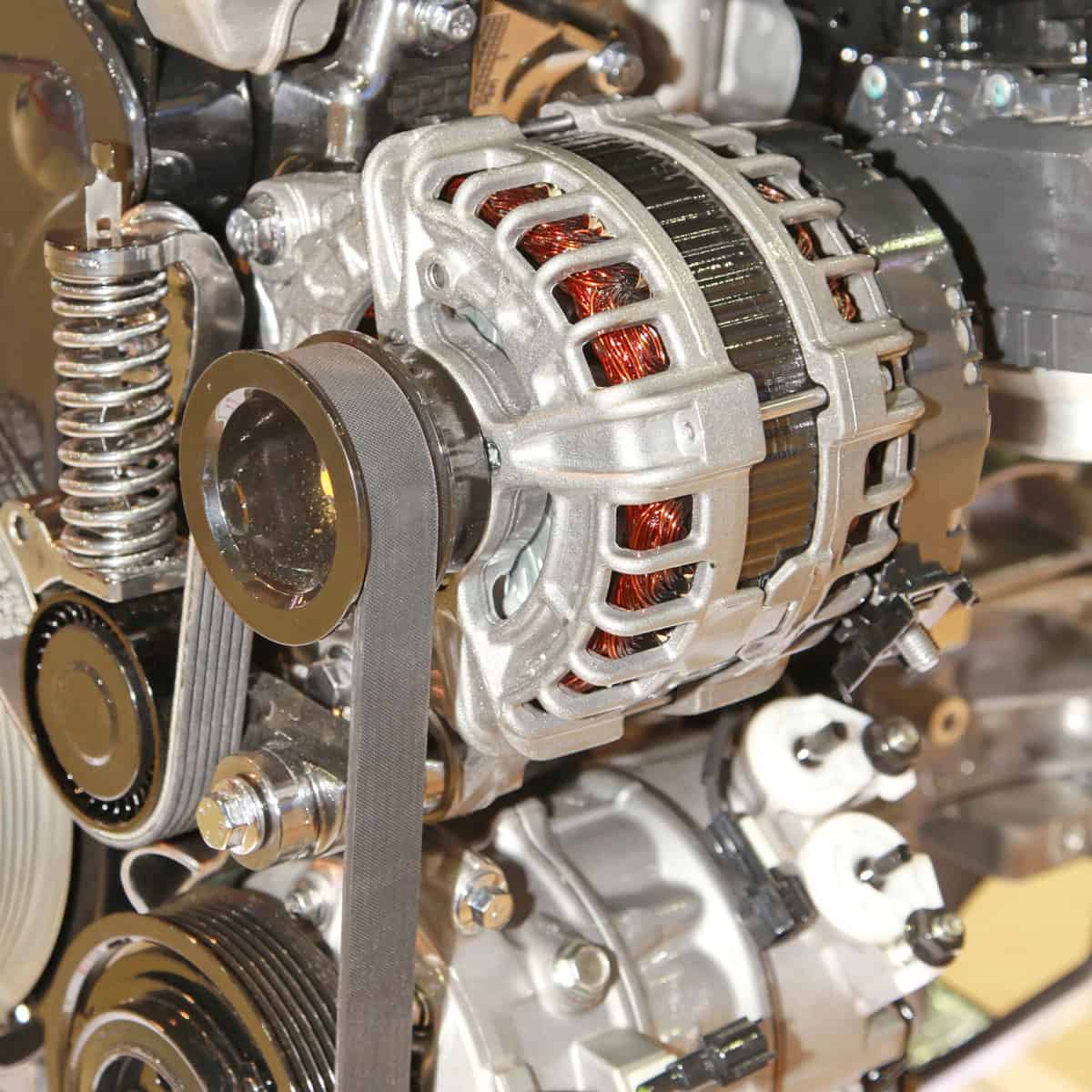 Car alternator converting mechanical energy to electrical energy inside a car